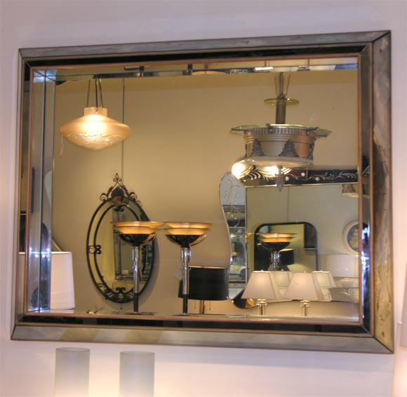 Clear mirror interior with antique smoked gray mirrored borders and wood trimmings.