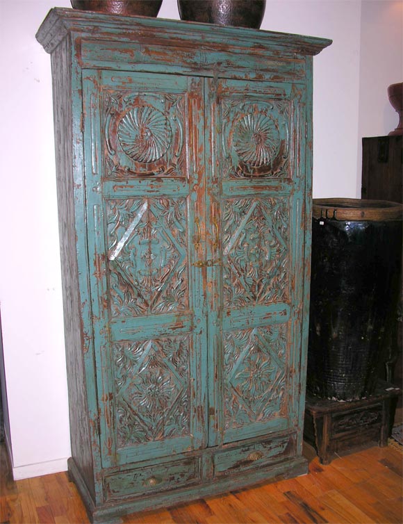 Colonial Armoire from Gujarat, Northern India, with beautiful turqoise hues. Detail carvings on front panels. Two lower drawers.