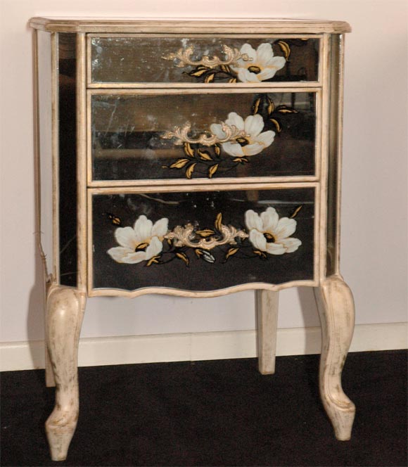 A stylish pair of 3 drawer bedside tables by New Era Glass.  The cabinets feature eglomise and 