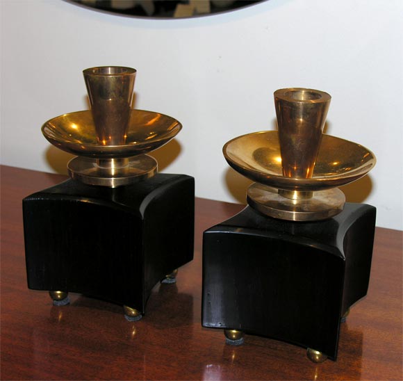 Copper and brass candlesticks with ebonized oak bases.