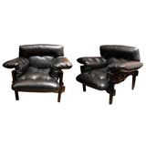 pair of sergio rodrigues black leather armchairs