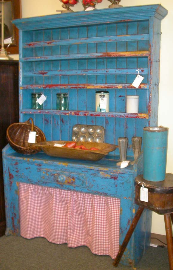 Early Irish country dresser, storage behind red-checked curtain (new fabric) in vivid blue paint, well worn.