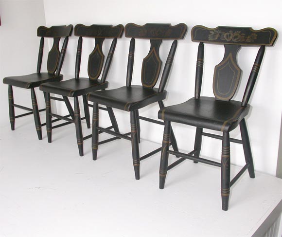 Set of four matching re-decorated plank bottom chairs great second coat of paint/gilded trim and stenciling on black ground-signed R. lackhove-1947 the chairs are from Lancaster Co. Penna. Wonderful patina to the gilded paint.