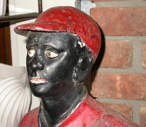 Cast Iron Lawn Jockey with original electric lamp.  Painted red with black face,hands and boots.