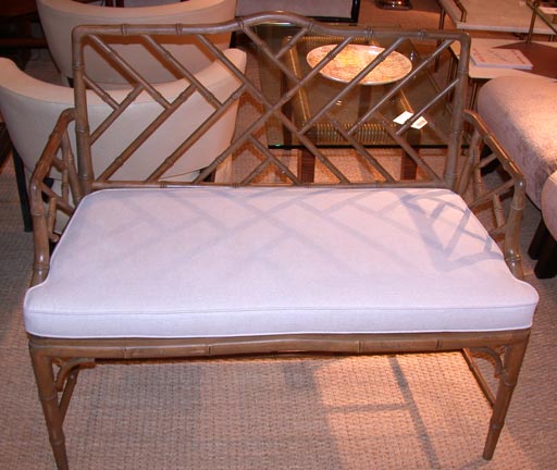 Faux-bamboo bench in the Chinese Chippendale style. Painted wood finish.  Linen covered cushion.