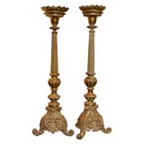 Pair of carved wood and gilded pricket sticks.