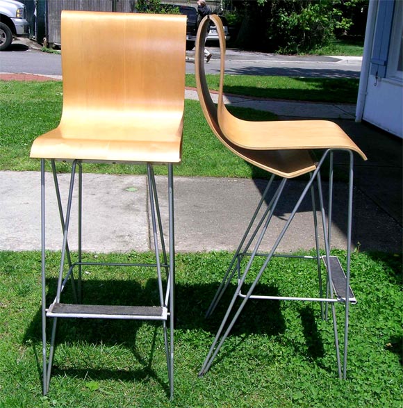 Rare bent plywood sculptural form stools with metal erector set supports and footrest. Signed on underside.