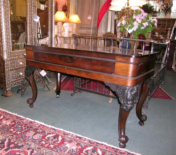A AMERICAN ROSEWOOD SPINET PIANO CASE WAS CONVERTED TO A SPINET DESK, IN THE 1920'S WITH ATTENTION TO DETAIL AND WITH CARE. THE EAGLES ON EACH CORNER ARE MADE OF IRON.
