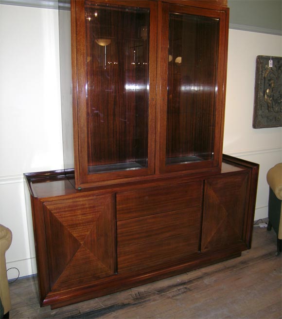 Mahogany cabinet with beveled glass doors, on sideboard with 3 drawers and 2 two pyramid releif doors.