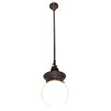 Antique electrified gas fixture with white globe