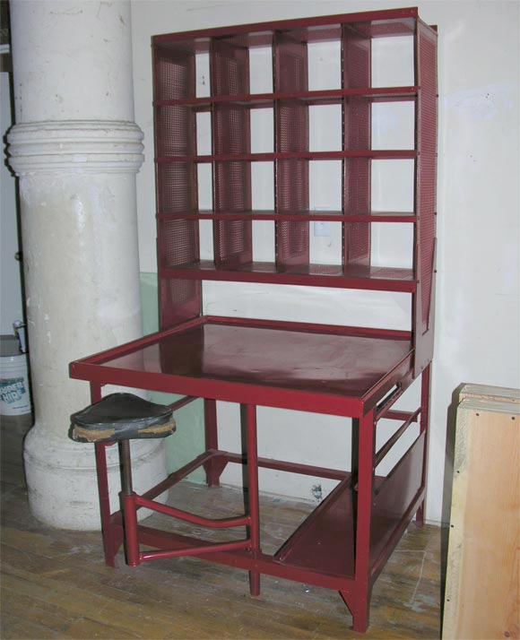 Metal desk with a perforated filing partition. Desk were used in the early 
1900, perhaps earlier, by Frances postal service for sorting and filing mail. Some have swing chairs and some are without. All have the perforated top that slides to each