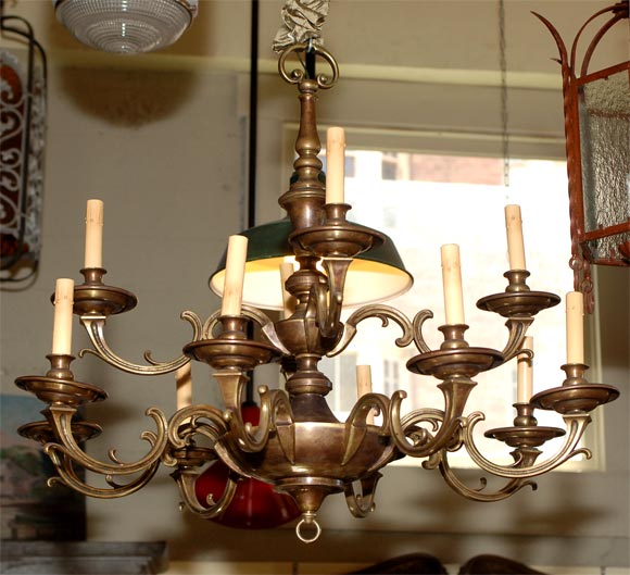 Continental/Baroque-style 12-arm bronze chandelier with baluster-shaped center support. Wonderful color, patina and good size. Measurements do not include the chain