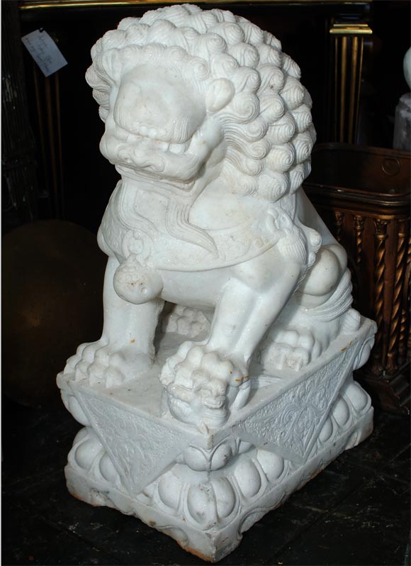 Pr. of 20th century finely carved large white marble Chinese foo dogs on attached elaborate plinths. Foo dogs came from a San Francisco garden.<br />
Originally priced at $4500.