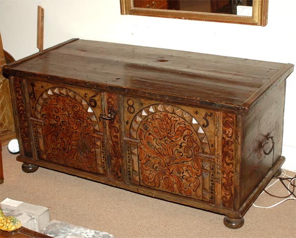 A beautifully painted 17th century paneled dowry chest.  Made in Sweden dated 1685.  Painted in olives, browns, rusts and black.  With original lock and hardware.
