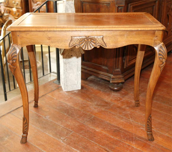 Graceful and beautifully carved walnut table