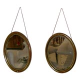 Pair of oval gilt mirrors