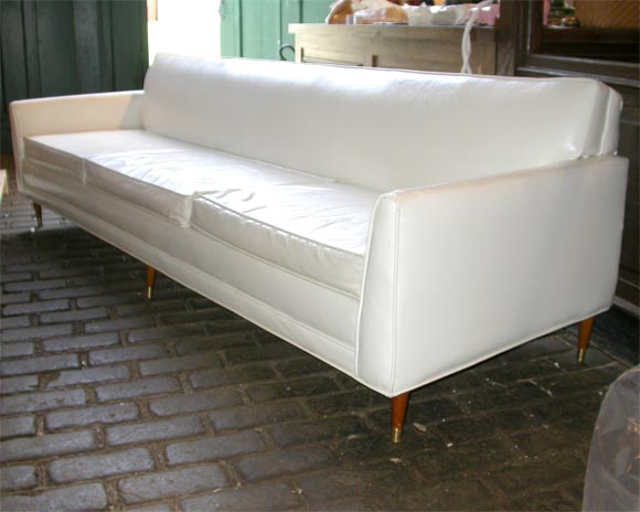 Three cushion, tight back white vinyl lawson sofa