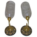 pair of sconces with large glass globes and wood backplates
