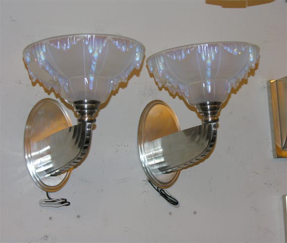 Satin nickel-plated bronze sconces with opalescent glass shades. Shades signed Ezan, France. Two pairs available.