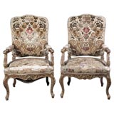 Pair of Louis XV style parcel gilt Armchairs
