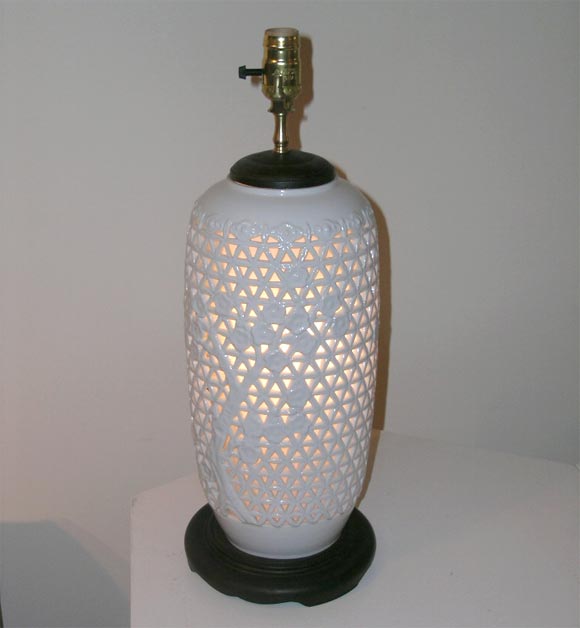 Large pair of ceramic oriental influenced lamps, in a pierced lattice design and inner light concealed by rice paper, mounted on wooden bases and newly rewired with silk rayon cords.