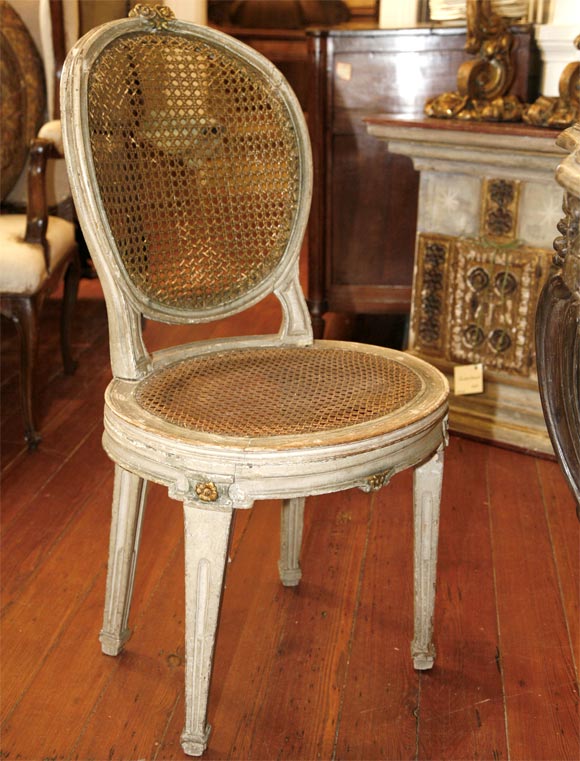 Four Louis XVI cane seat side chairs.
