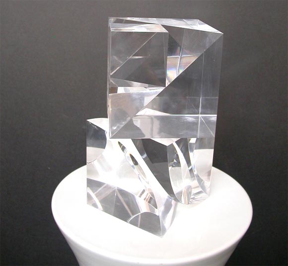 A wonderful set of 2 Lucite cubes of varing design which can be used either as bookends or as distinct sculptural elements.