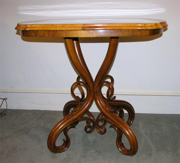 An oval bentwood table by Thonet.