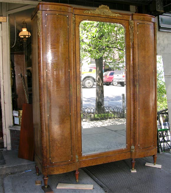 A fine French 3 Door Armoire (center with beveled mirror) made of yew wood, with rosewood inlay, and original bronze mounts. With interior shelves. Separates for easy moving.