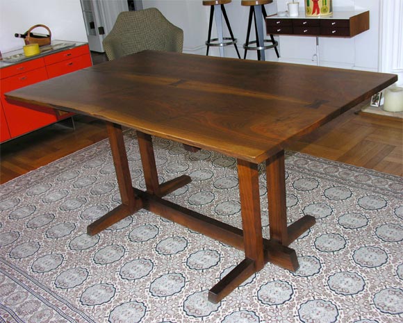 An exceptional example of an American black walnut dining table by George Nakashima.  Made in 1979.  Excellent bookmatched top, with two free edges and amazing sap lines.  Three butterflies made of rosewood and a Frenchman's cove base.<br />
<br