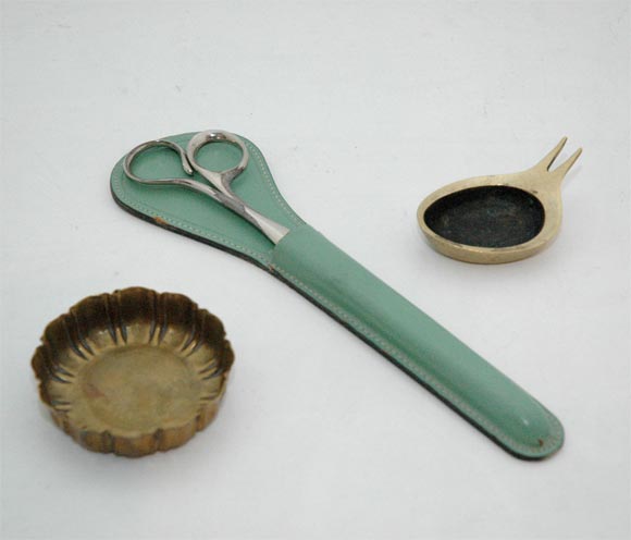 A hammered brass dish by Josef Hoffmann for the Wiener Werkstatte (fully marked with the WW and JH devices); a pair of scissors with leather holster by Antonia Campi; and a lovely little zoomorphic ashtray / pipe holder by Carl Aubock.