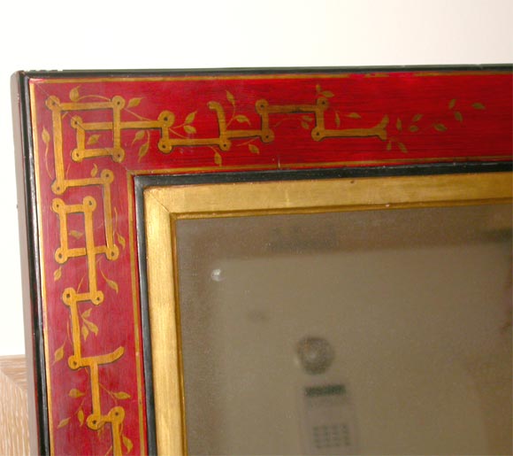 Molded gilded inner frame, set into a red lacquer frame with gilded brass mounts accented by gilt-painted Chinese designs --people, temples, etc., with framed and paneled board back characteristic of the late 19th century; Reverse of frame has paper