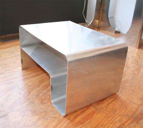 Folded minimalist steel table with brass clips by French designer Joelle Ferlande