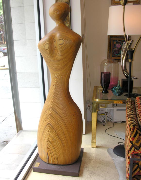 Tall laminated wood sculpture of a woman, 