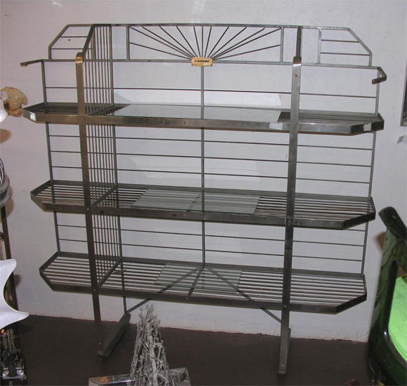 large iron and aluminum deco bakers rack. wonderful geometic patterns, as much a scupture as a piece of function.