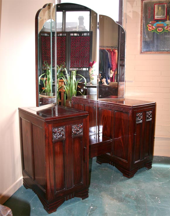 A glamourous Chinese Deco dressing table from 1930's Shanghai with three paneled pivoting mirrors, carved fruit relief cartouches on doors, and a hidden drawer in center shelf.<br />
<br />
Pagoda Red Collection #:  GDE091