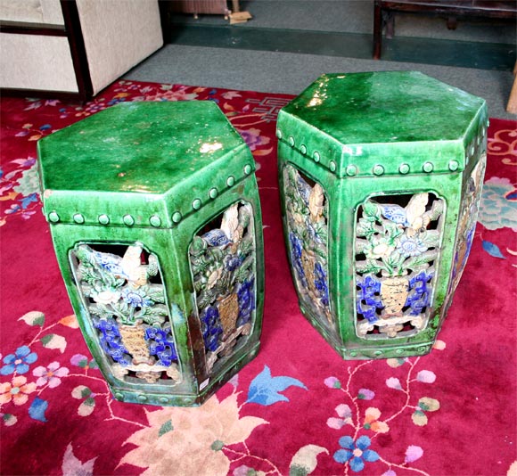 Turn-of-the-century glazed ceramic garden seats with six perforated sides depicting a vase of flowers in blue and yellow.