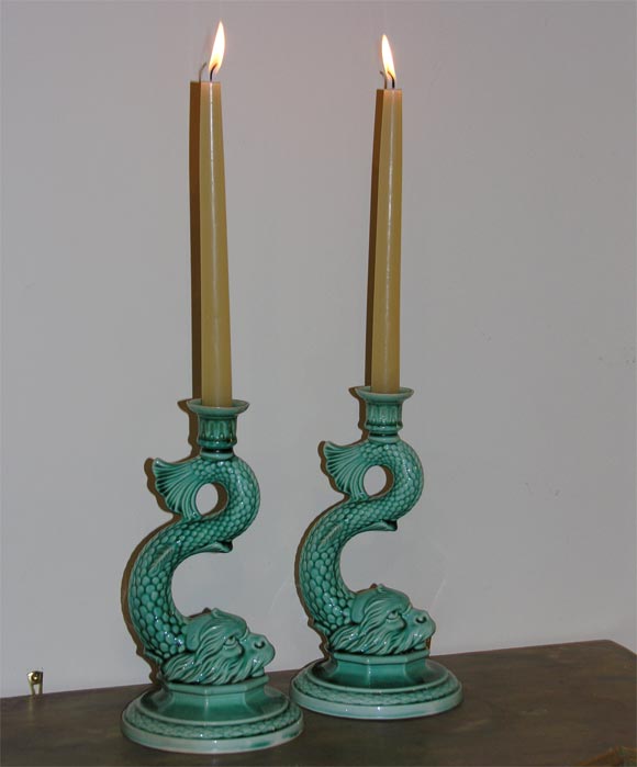 A pair of French Majolica Candlesticks in the form of Dolphins in a turquoise aqua glaze.