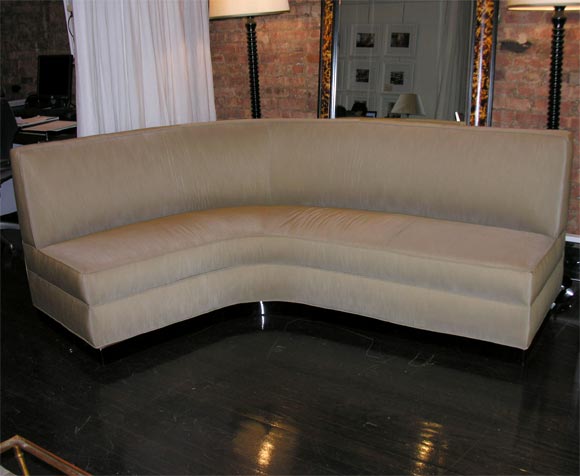 sectional sofa by J Royere, upholstered in Shantung on an ebonized mahogany base.