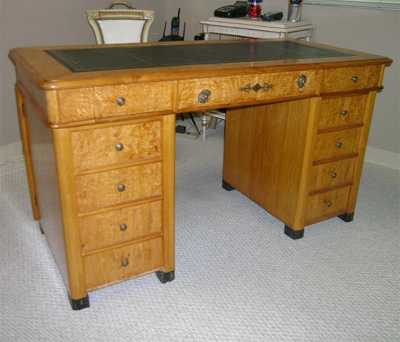 The desk has the original hardware. The desk has faux drawers on one side.