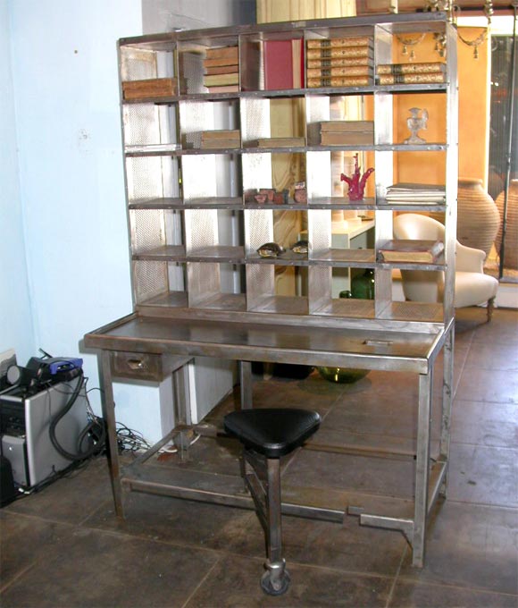 Polished Steel Desk, used by French Postal Service to sort Mail.  25 Compartments, with Work surface, and two drawers, and Attached Pivotal Stool with Leather cushioned seat
