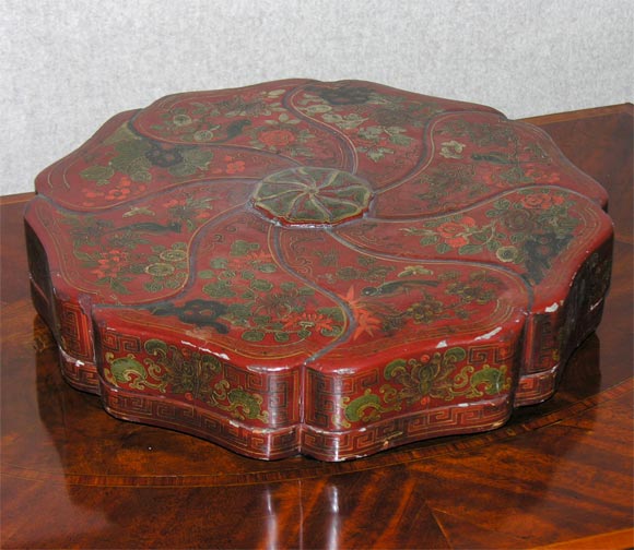 Scalloped edge, Laquer designs <br />
of birds and flowers against <br />
a cinnabar colored background