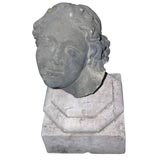 Female head mounted on marble base.