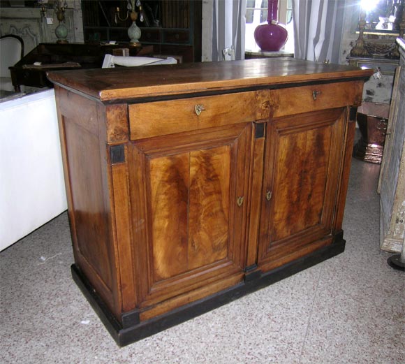 The walnut two-door buffet is from the French Restoration period, circa 1840. The patina is very good; note the black detailing and front panel burling.