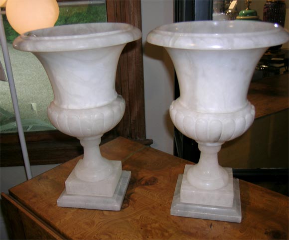 Pair of electrified alabaster urns on a 6.5 inch base