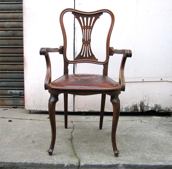 Beautiful Biedermeier armchair with lyre-back and waffle-patterned leather seating.