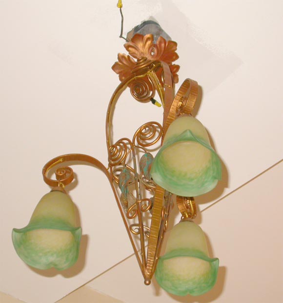 Three shade French deco chandelier by Rethondes. The frame is done in a copper with green accents and the shades in a yellow and green glass.