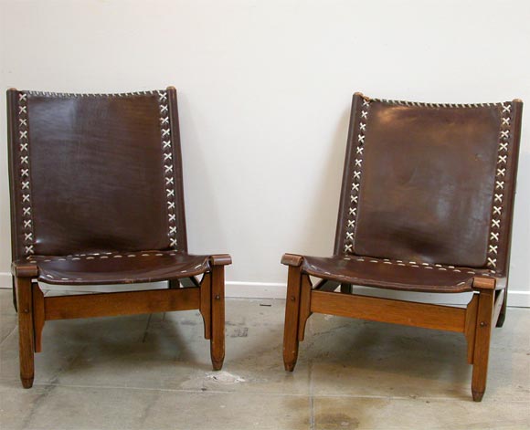 Pair of armless low slung leather chairs.  Original chocolate brown leather and white stitching. Extremely comfortable and beautifully designed.   Seat height 12