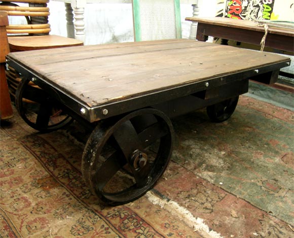 Iron industrial cart with wooden top.