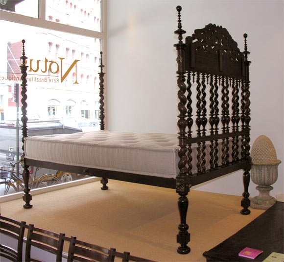 Early 19th C Indo Portuguese brilos style four poster bed. The magnificent head board is crowned with carved phantastiques supported on barley twist turnings and decorated with carved finials. In Rosewood. With custom mattress suitable for a day bed.